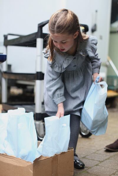 Princess Charlotte, who celebrated her fifth birthday in May, handing out food parcels during the coronavirus pandemic. Reuters / The Duchess of Cambridge