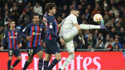 Real Madrid's Karim Benzema in action against Marcos Alonso of Barcelona. EPA