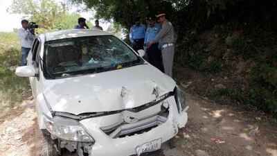 Pakistan police inspect the car which Chaudhry Zulfiqar was driving when he was shot dead by gunmen in Islamabad today,