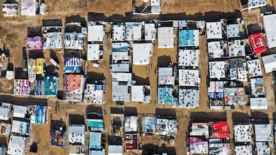 An aerial view shows an informal tent settlement housing Syrian refugees in the area of Delhamiyeh, in the central Bekaa Valley on January 17, 2019. Lebanon plays host to over one million Syrian refugees who fled as neighbouring Syrian fell into civil war at the start of March 2011. / AFP / JOSEPH EID
