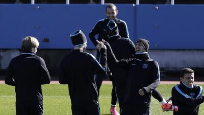 Luis Suarez laughs with teammate during Barcelona’s training session. Kiyoshi Ota / EPA
