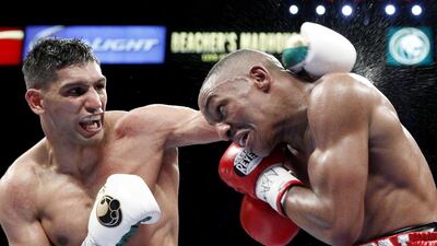 Amir Khan, left, in action during his last fight - a convincing points victory over Devon Alexander on December 13. Steve Marcus / Reuters