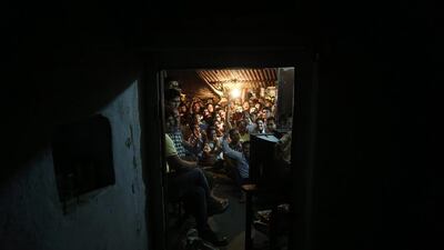 Indian cricket fans celebrate as Virat Kohli plays a shot in the ICC Twenty20 Cricket World Cup final match between India and Sri Lanka while watching on a television set at a roadside shop in Allahabad, India. Rajesh Kumar Singh / AP