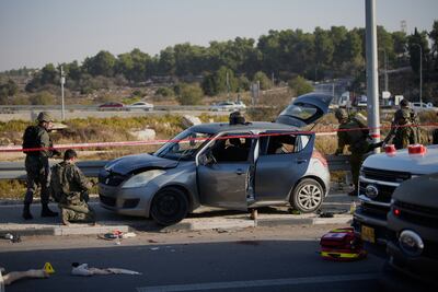 Members of Israeli security forces inspect the site of a ramming and stabbing attack near the Jewish settlement of Gush Etzion, in the occupied West Bank. AP