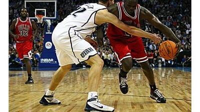 Luol Deng of the Chicago Bulls, right, takes on Spencer Nelson of the Utah Jazz during the NBA pre-season game as part of the 2009 NBA Europe Live Tour in London.