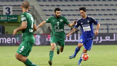 Al Nasr’s Luis Jimenez, right, avoids Al Shabab defenders during their league match in Dubai on Thursday night. Pawan Singh / The National