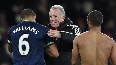 Swansea City interim manager Alan Curtis celebrates with Ashley Williams after the game against Arsenal. Reuters / Dylan Martinez