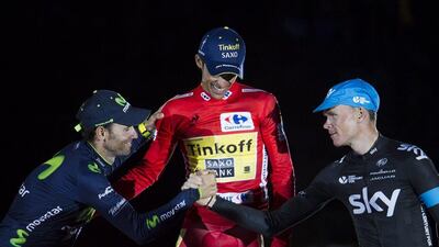 Winner Alberto Contador, centre, with second-placed Chris Froome, right, and third-placed Alejandro Valverde, left, celebrates his Vuelta a Espana victory on Sunday. Jaime Reina / AFP / September 14, 2014