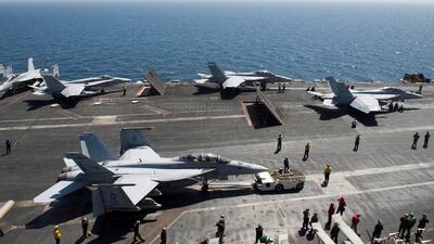 Aircraft are prepares for operations on the flight deck of the aircraft carrier USS Theodore Roosevelt on May 19, 2015, in the Gulf region. D’Artanyan Ratley / US Navy / AFP
