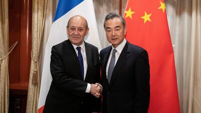 China's Foreign Minister Wang Yi shakes hands with his French counterpart Jean-Yves Le Drian at Diaoyutai State Guesthouse in Beijing, China. Reuters