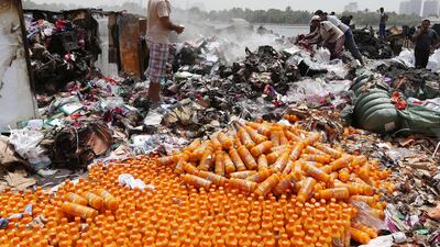 The charred remains of some of the merchandise – food, electronics, car batteries, soft drinks, electrical goods, blankets and more – that had been on the three dhows that caught fire on Dubai Creek on Monday. Pawan Singh / The National