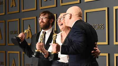 US directors Julia Reichert, Jeff Reichert (R) and Steven Bognar (L) pose in the press room with the Oscar for Best Documentary Feature for "American Factory" during the 92nd Oscars. AFP