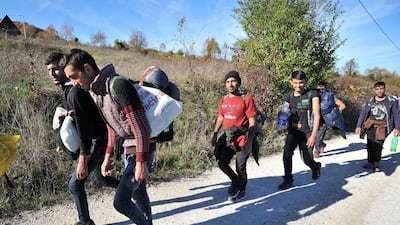 A group of Asian migrants are seen while marching on a dirt road, while attempting to illegally cross into Croatia via Pljesevica mountain, near Northern-Bosnian town of Bihac. AFP