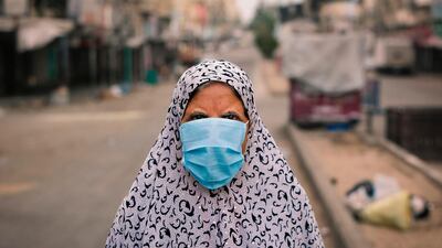 A Palestinian woman walks along a street in Gaza City. AFP