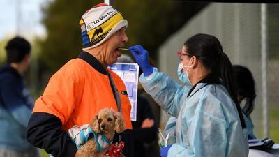 A medical professional administers a test to a member of the public at a pop-up coronavirus testing facility in Melbourne, Australia. Reuters