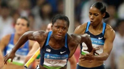 Mechelle Lewis of the United States comforts her team mate Torri Edwards after she dropped the baton.