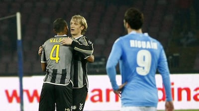 Naldo, left, and Dusan Basta, right, celebrate after scoring as Gonzalo Higuain looks on. Carlo Hermann / AFP
