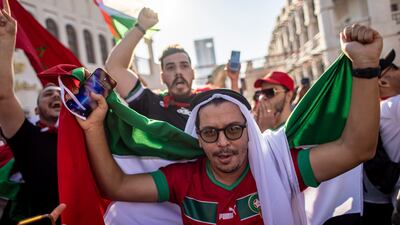 Fans of Morocco wave flags at the Souq Waqif market. EPA