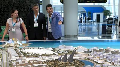 Visitors look at a scale model of the Saadiyat Island project by the Tourism Development & Investment Company. Ravindranath K / The National