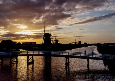 One of the hot topics at the moment is the impact of renewable energy projects, such as modern windmills on the Netherlands' 18th century Mill Network at Kinderdijk. AP