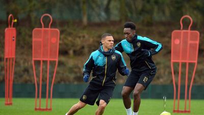 Arsenal's English defender Kieran Gibbs (L) and English striker Danny Welbeck take part in a training session ahead of the UEFA Champions League round of 16 1st leg football match against Barcelona at Arsenal's London Colney training ground on February 22, 2016. Arsenal will play against Barcelona at the Emirates Stadium in London on Tuesday February 23, 2016. / AFP / GLYN KIRK