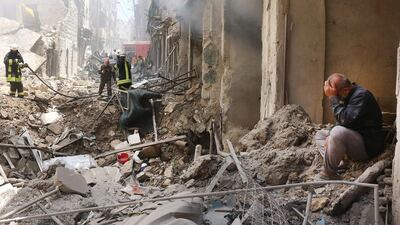 A man sits on the rubble of a destroyed building following reported air strikes by government forces in the rebel-held Shaar neighbourhood of Aleppo city on June 8, 2016. Thaer Mohammed / Agence France-Presse