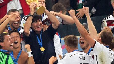 Germany coach Joachim Loew, centre, lifts the World Cup trophy after his side's victory in July in the World Cup final over Argentina. On Monday night, January 12, 2015, Loew was named Coach of the Year at the Fifa Ballon d'Or gala in Zurich, Switzerland. Marcus Brandt / EPA / July 13, 2014