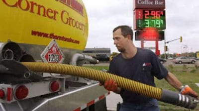 Gas truck delivery driver Tim Trabue packs away gas lines after unloading gas into underground holding tanks at a gas station in Springfield, Ill., US, on Oct 15 2008. Oil prices dipped below $70 a barrel, a new 15-month low.