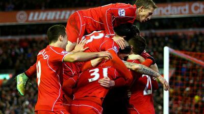 Adam Lallana of Liverpool celebrates with teammates after scoring his team's second goal in their 4-1 Premier League victory over Swansea City on Monday night at Anfield. Clive Brunskill / Getty Images / December 29, 2014
