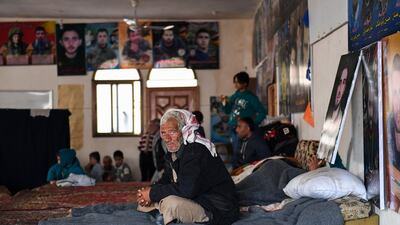 A man fleeing from the Turkish offensive on the Syrian Kurdish town of Afrin takes refuge in a shelter in the town of Nubol, 26 kilometres northwest of Aleppo, adorned with posters of Lebanese Shiite movement Hezbollah, Iran's Supreme Leader, and the Syrian President. George Ourfalian / AFP