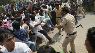 Indian police try to control mourners gathered in Mumbai. Divyakant Solanki / EPA