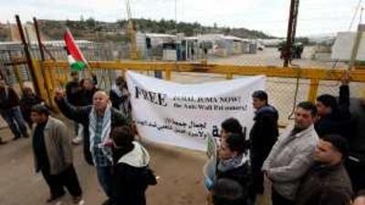 Relatives of Jamal Juma' take part in a protest along with activists to demand his release, at the Bitwnia Checkpoint near Ramallah.