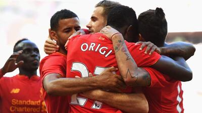 Liverpool players congratulate Divock Origi after his goal made it 3-0. Mike Hewitt / Getty Images