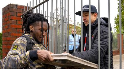 Wrexham co-chairman Rob McElhenney signs an autograph for a fan. PA