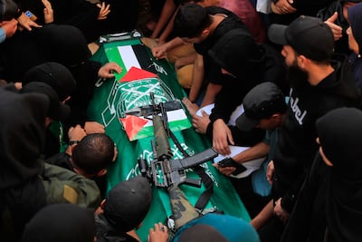 Mourners surround the coffin of one of the Palestinian victims. AP
