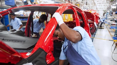 Employees work on the final assembly of cars at the Ford facility in Chennai. Bloomberg