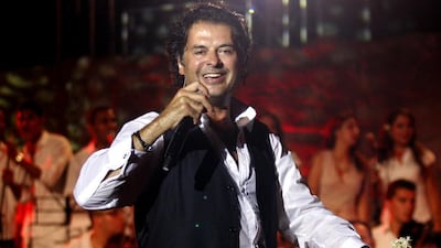 The Lebanese singer Ragheb Alama, who plays in Abu Dhabi tomorrow, is also a judge on the TV show Arab Idol and a UN climate change ambassador. AFP / Fethi Belaid