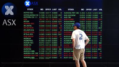 A man watches the shares prices listed at the Australian Stock Exchange in Sydney, Australia. The bourse has stopped trading for the day after a glitch caused problems. Paul Miller / EPA