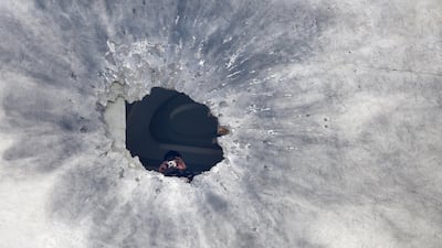A security officer inspects a rocket hole in a private building in downtown Kabul, Afghanistan. According to media reports at least one person was killed and three others were injured as several rockets landed on the Afghann capital. EPA