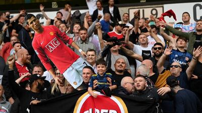 WOLVERHAMPTON, ENGLAND - AUGUST 29: Fans of Manchester United hold up a cardboard cutout of New Signing Cristiano Ronaldo during the Premier League match between Wolverhampton Wanderers and Manchester United at Molineux on August 29, 2021 in Wolverhampton, England. (Photo by Shaun Botterill / Getty Images)