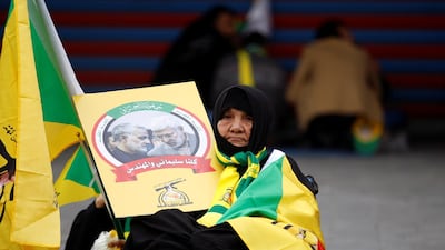 A woman holds the picture of the Iranian Major-General Qassem Suleimani ahead of the funeral in Baghdad. Reuters