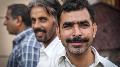 A man poses for a portrait outside a mosque by Ricardo Groenke. Courtesy Frying Pan Adventures and Gulf Photo Plus