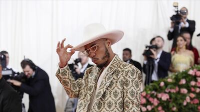 Rapper Anderson Paak arrived in a brocade jacket and pink trousers. The half moon glasses and felted hat was a nice touch. EPA