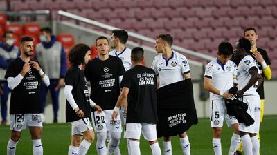 Getafe players are seen wearing a t-shirt with a message against the European Super League before the match against Barcelona. Reuters