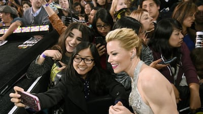 Director/producer Elizabeth Banks poses for a photo with a fan at the world premiere of Pitch Perfect 2. AP
