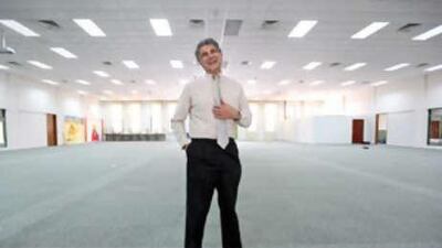 Dr James Mirrione poses in the "uni-purpose" room that serves as an impromptu theatre at United Arab Emirates University in Al Ain.
