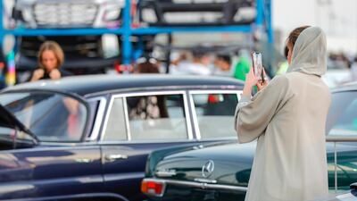 A Mercedes Benz car fan takes a snap of the collectors cars at the Gulf Car Festival 2019, Festival City Mall. Victor Besa/The National
