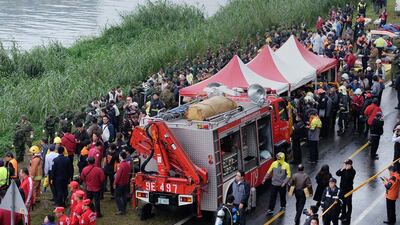 The ATR 72 prop-jet aircraft was flying on its side, with one wing scraping past Taiwan’s National Freeway No. 1 just seconds before it plunged into the river. Sam Yeh / AFP Photo