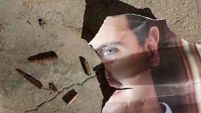 A torn portrait of former Syrian president Bashar Al Assad on the outskirts of Damascus, December 16. Syrians keenly understand the fragile and unpredictable nature of the political transition that is taking place. EPA