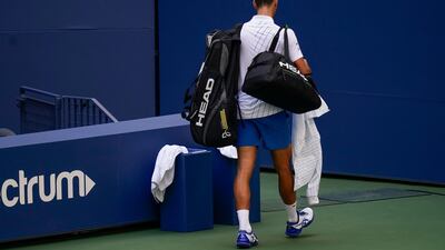 Novak Djokovic leaves the court after his disqualification. AP